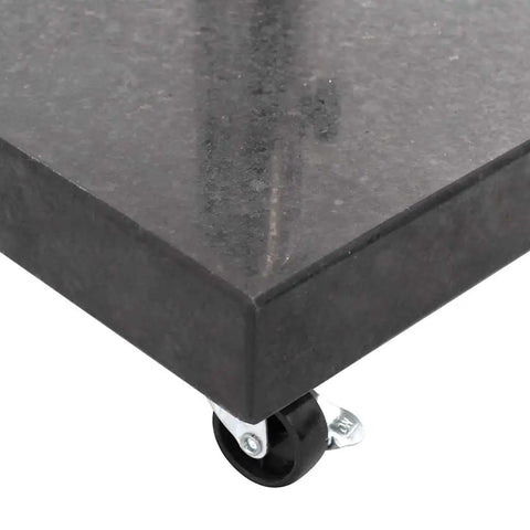 Close-up of Rock Solid Parasol Base In Black Granite With Stainless Steel Construction Square Design showing wheel corner