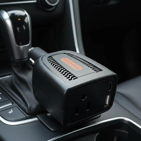 Ultra Compact 100W Power Inverter With Wicked Quiet Fanless Design, car charger adapter in vehicle center console.