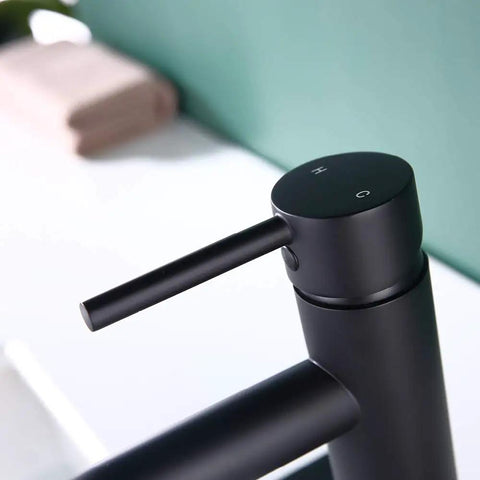 Close-up of Single Handle Matte Black Bathroom Faucet With Metal Drain Assembly And Escutcheon Water Efficient 1.2 GPM Flow