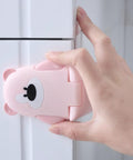 Installing Three Pack Kid Safe Safety Cabinet Locks With Non Marking Adhesive And 90 Degree Curved Bear Shape Cartoon Locks on cabinet.