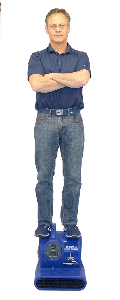 Man standing on heavy duty air mover and carpet dryer with three quarter HP motor delivers 2800 CFM and durable housing.