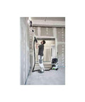 Worker using PLANEX LHS 2 225 EQI Plus Drywall Sander With LED Ring Light on ceiling, showing adjustable suction and dust control.