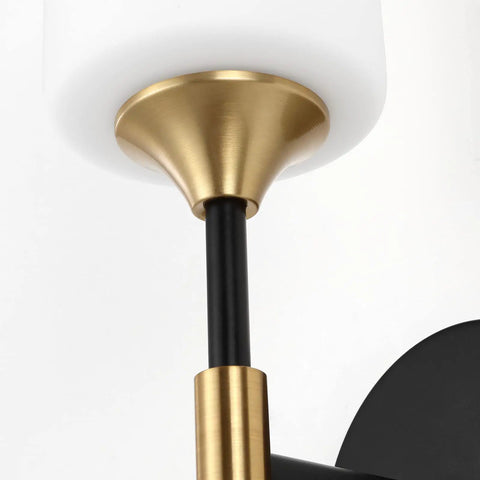 Close-up of Industrial Mid Century Wall Sconce Set Of 2 With White Cylinder Glass Shades For Modern Bathroom Vanity In Matte Black And Brushed Brass Finish