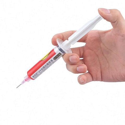 Hand holding Red UV Curable Solder Mask 10cc For PCB And BGA Circuit Boards Protects Solder Paste Fluxes And Welding Fluxes Oil