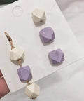 Unpainted Faceted Geometric Wood Beads 16mm With 3.5mm Holes Natural Color For DIY Jewelry Making 100 Pieces Dope For Necklaces Keychains And Crafts Assortment, featuring a mix of purple and natural wood beads.