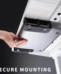 Hand securing a laptop in a Heavy Duty Under Desk Laptop Holder, illustrating setup for tidy workspace with strong grip.