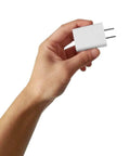 Hand holding USB Wall Charger 5V 2A Fast Charging Plug For iPhone iPad Samsung Kindle And More 100-240V Travel Ready White 2 Pack.