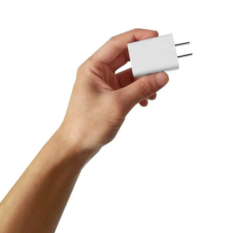Hand holding USB Wall Charger 5V 2A Fast Charging Plug For iPhone iPad Samsung Kindle And More 100-240V Travel Ready White 2 Pack.