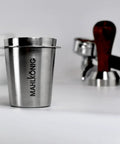 Barista Level Electric Coffee Grinder With Stepless Control And 54Mm Steel Flat Burrs Delivers Hella Consistent Grounds For Quick Home Brewing Features A Sleek Chrome Body And Easy Clean Design To Keep Your Daily Cup Straight Up Perfect, stainless steel cup with Mahlkönig logo.