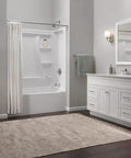 Bathroom with white vanity, mirror, and bathtub featuring Foundations Centerset Chrome Bathroom Faucet With One Handle For 3 Hole 4 Inch.