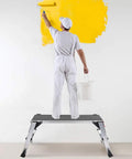 Man painting wall standing on Beast Mode Rugged Aluminum Work Platform Foldable Large Size Step Stool Work Bench With Non Slip Mat 660 Lbs Capacity