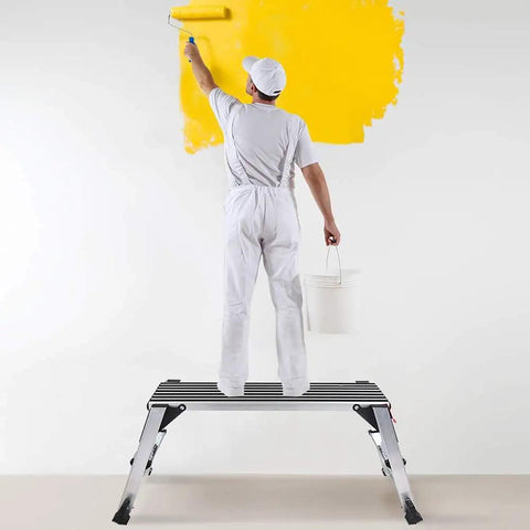 Man painting wall standing on Beast Mode Rugged Aluminum Work Platform Foldable Large Size Step Stool Work Bench With Non Slip Mat 660 Lbs Capacity