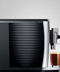 Level Up Your Daily Grind With This Sleek Chrome Automatic Coffee Machine Boasting One Touch Operation Built In Grinder And Rich Foam Frother For A Real Deal Barista Experience Certified Refurbished, coffee machine side view with espresso cup.