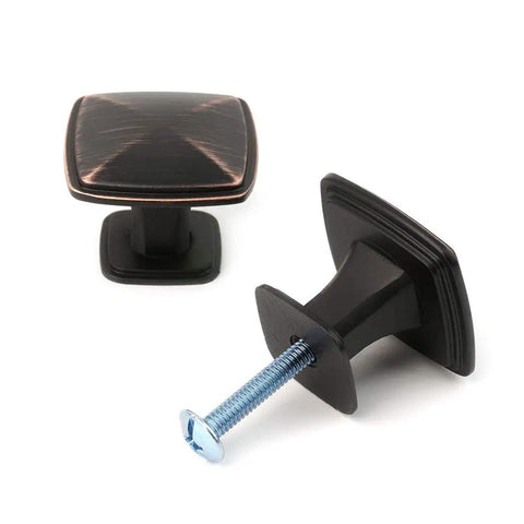 Close-up of Ten Pack Oil Rubbed Bronze Cabinet Knobs Set For Cabinets And Drawers Square Single Hole Pulls For Dresser Cupboard Bedroom Closet And Bathroom Vanity Made From Solid Metal For Durable Easy Install Hardware The Best Bang For Your Buck showing two knobs, screws visible.