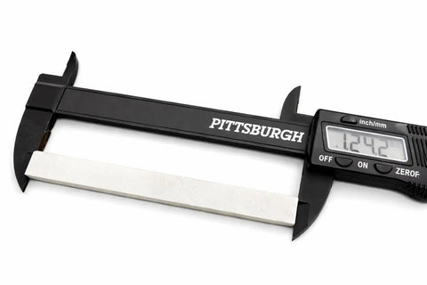 Digital caliper measuring a soapstone from Welding Soapstone Refills 36 Pack For Metal Marking, Five Inches By One Half By Three Sixteenths Stones.