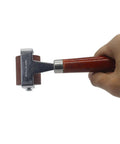 Hand holding Soft Rubber Brayer Roller with Wooden Handle for Printmaking, 32x38 mm roller, heavy stainless steel frame, side view
