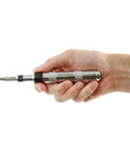 Hand holding Mini Impact Driver Set With One Quarter Inch Drive For Tight Spaces, Durable And Compact Automotive Tool