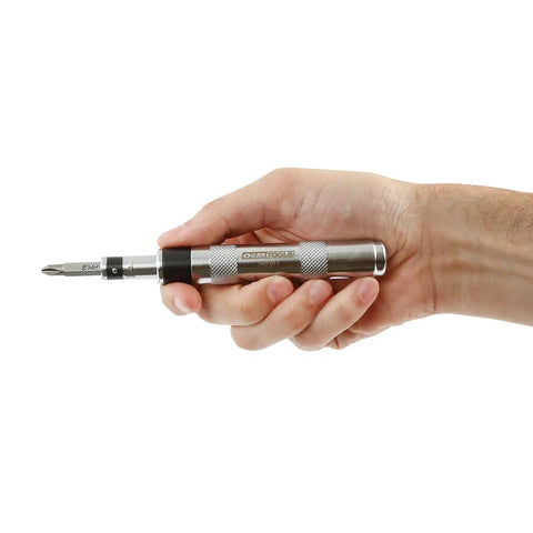 Hand holding Mini Impact Driver Set With One Quarter Inch Drive For Tight Spaces, Durable And Compact Automotive Tool