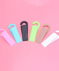 Set Of 6 Thermoplastic Rubber Door Stopper Wedges For Anti Slip Protection And Finger Pinch Prevention, various colors on pink background