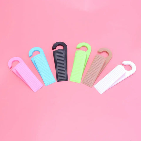 Set Of 6 Thermoplastic Rubber Door Stopper Wedges For Anti Slip Protection And Finger Pinch Prevention, various colors on pink background