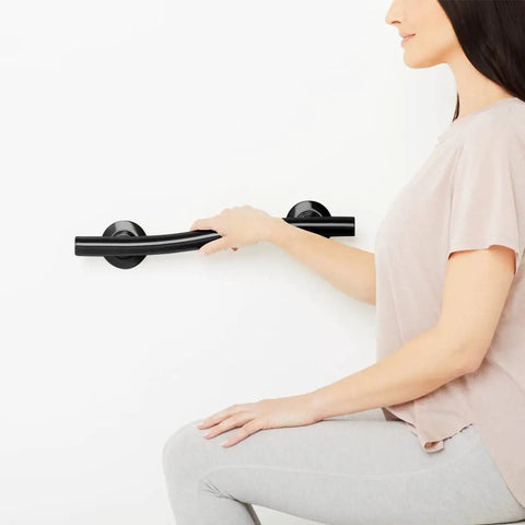 Woman holding 36 Inch Designer Wave Shaped Shower Grab Bar In Matte Black, Dope Modern Bath Safety Rail With One And One Quarter Inch Diameter
