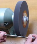 AmaCupid deburring wheel, nylon fiber buffing wheel, 8-inch, 180 grit silicon carbide, 5/8-inch arbor, side view on bench grinder