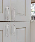 Seahorse Shaped Drawer Pulls Ocean Theme Marine Style Cabinet Hardware Zinc Alloy Coastal Metal Decorative Pulls for Dresser Chest Cabinet Cupboard and Closet in Durable Silver Finish installed on white kitchen cabinet doors.