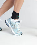 Person wearing Airheel Ankle Support With Stabilizers For Fast Swelling Relief And Better Circulation, stretching on white floor