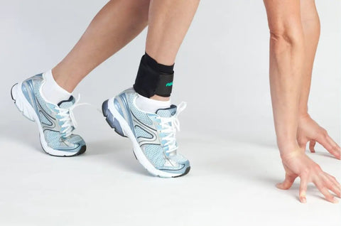 Person wearing Airheel Ankle Support With Stabilizers For Fast Swelling Relief And Better Circulation, stretching on white floor
