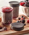 Regular Mouth Mason Jar Leak-Proof Lids, 6-Count, BPA-Free plastic covers shown sealing jam jar on wooden board with berries