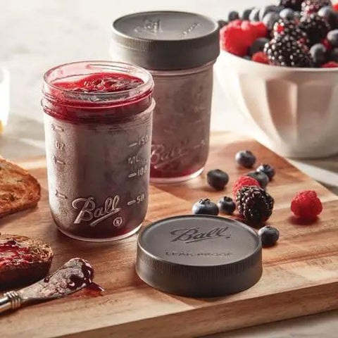 Regular Mouth Mason Jar Leak-Proof Lids, 6-Count, BPA-Free plastic covers shown sealing jam jar on wooden board with berries