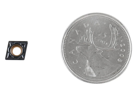 CCMT 21.51 MD Carbide Insert With CVD Coating For Steel Machining beside a coin for size comparison