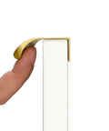 Side view of 10 Pack 5 Inch Matte Gold Finger Pulls For Cabinets And Drawers Brushed Brass Edge Hardware, installed on a white surface.
