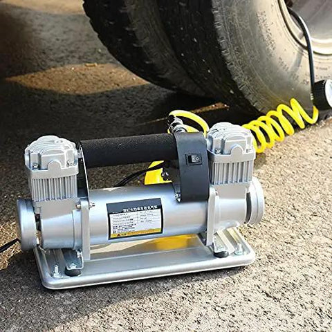 Kick Serious Fluid With This Straight Up Heavy Duty Electric Submersible Pump Built To Run Smooth On 12V Or 24V Power While Functioning As A Whisper Quiet Auto Air Compressor And Grit Proof Sump Pump on a surface near a tire.