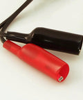 Close-up of 69411 Circuit Breaker Finder Accessory Kit with red and black alligator clips, part of durable electrical testing tools.