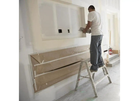Man applying 18Lb EZ Sand 45 joint compound for drywall and painting projects on a wall, smooth finish, pro grade sandable gypsum formula