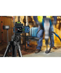 Blaze Green Beam Laser Measure Up To 165 Feet With Real Time Distance Reading on tripod in construction site