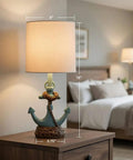 Anchor Accent Lamp With Cozy Coastal Vibe In Antique Iced Blue Resin Anchor Base on bedroom nightstand, 16 in tall, 8 in diameter