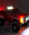 Plug And Play Front And Rear LED Light Kit With Headlights And Taillights For One Eighteenth Scale TRX4M K10 RC Crawler Upgrades Easy Install And Realistic Nighttime Look showing red TRX4M K10 with illuminated lights.