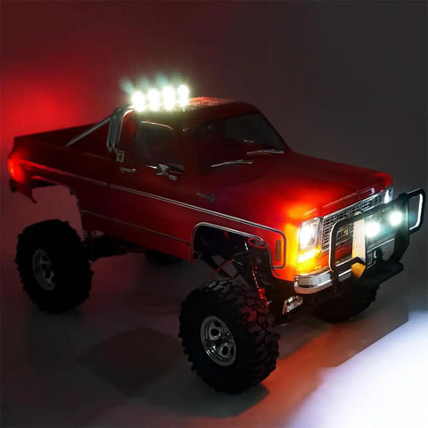 Plug And Play Front And Rear LED Light Kit With Headlights And Taillights For One Eighteenth Scale TRX4M K10 RC Crawler Upgrades Easy Install And Realistic Nighttime Look showing red TRX4M K10 with illuminated lights.
