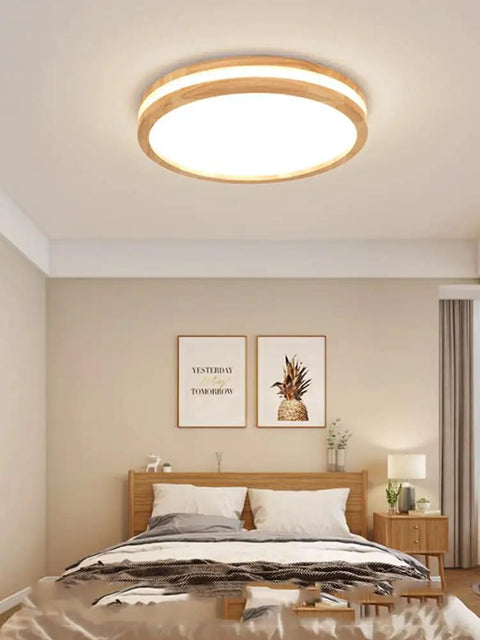 Wood LED Flush Mount Ceiling Light in a bedroom setting, modern round 15.8 inch 4000K ceiling lamp, creating cozy ambience.