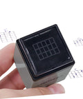 3 Piece Chord Stamp Toolkit For Ukulele And Guitar, Precision Marking Tool For Easy Chord Positions, Jam Ready Practice Charts, And Quick Memorization Across Multiple Instruments. black chord stamp tool in hand, square plastic body