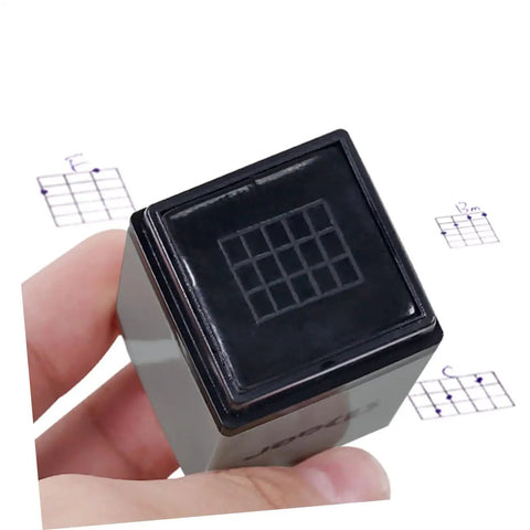 3 Piece Chord Stamp Toolkit For Ukulele And Guitar, Precision Marking Tool For Easy Chord Positions, Jam Ready Practice Charts, And Quick Memorization Across Multiple Instruments. black chord stamp tool in hand, square plastic body