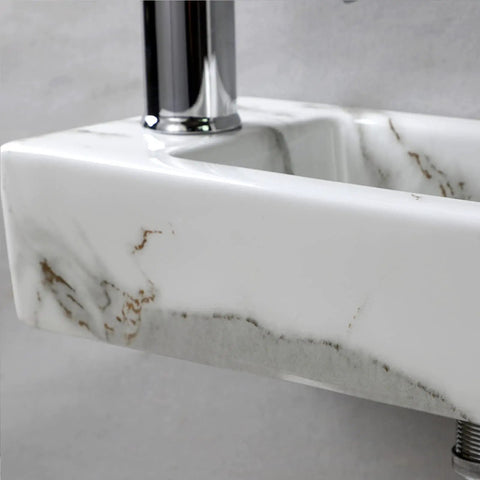 Close-up of compact white ceramic wall mounted sink for small bathrooms, rectangular vitreous china wash basin with glossy finish.