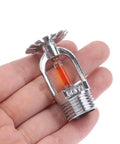 Top Notch Concealed Side Mount Fire Sprinkler Head 57 Celsius Quick Response Down Spray in hand showing glass bulb activation.