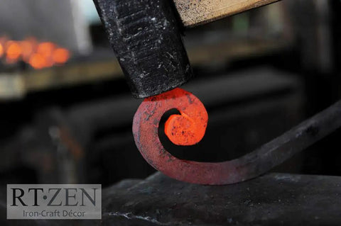 Close-up of a red-hot iron scroll being crafted, related to Handcrafted Wrought Iron Toilet Paper Holder In Black Matte, Wall Mount Bar