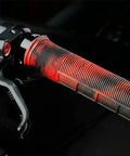 Red and black lock-on mountain bike handlebar grip with half-waffle pattern.