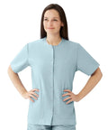 Women Snap Front Jewel Neck Scrub Top Double Cargo Pockets Misty Medium Cotton Polyester Blend Top worn by model, showcasing its light blue color.