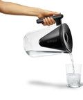 Person pouring water from 10 Cup Filtered Water Pitcher With Bamboo Handle, BPA Free Plastic, Clean Taste And Odor, Home Water Purifier