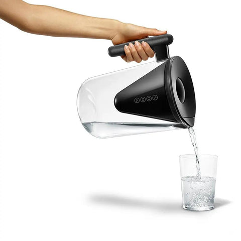 Person pouring water from 10 Cup Filtered Water Pitcher With Bamboo Handle, BPA Free Plastic, Clean Taste And Odor, Home Water Purifier